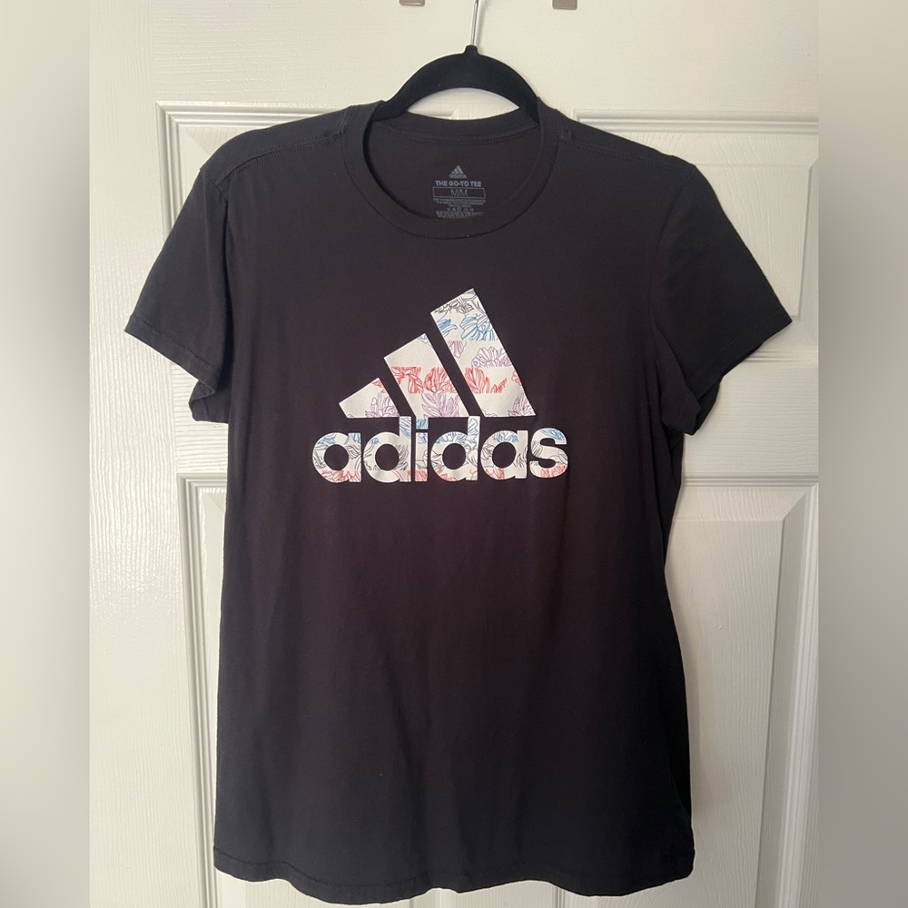 Adidas medium T-shirt multi color flower logo.